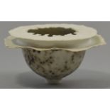 DEIRDRE BURNETT (born 1939); a footed porcelain bowl with double irregular rim, mottled matt