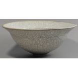 DAVID ROBERTS (born 1947); a large coil built footed raku bowl, white crackle glaze and unglazed