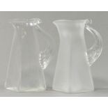 STEVEN NEWELL (born 1948); two square glass jugs, one clear, one opaque, incised signature, height
