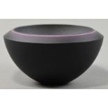 RACHAEL WOODMAN (born 1957); a bevelled glass bowl, black and grey with luminous pink, incised