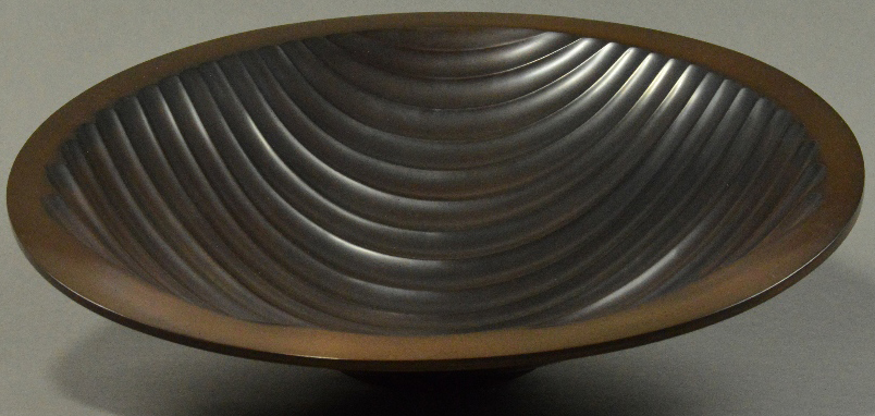 ALEX BROGDEN (born 1954); a double skinned copper 'Wave' footed bowl, fluted with wavy lines,