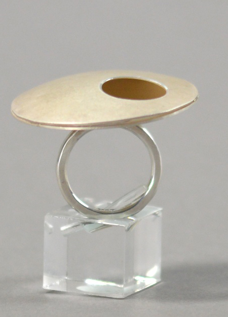 HANNAH SOUTER; a hallmarked silver ring with pierced disks, diameter 4cm, ring size N.