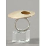 HANNAH SOUTER; a hallmarked silver ring with pierced disks, diameter 4cm, ring size N.