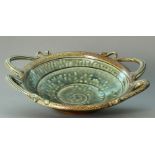 WALTER KEELER (born 1942); a salt glazed dish, four ornate handles, incised spiral to well, blue/