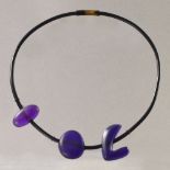 KATHIE MURPHY; a purple resin neckpiece on rubber thong, drop length 25cm.

Provenance: Purchased in