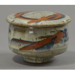 COLIN KELLAM (born 1942); a stoneware footed pot and cover with wax resist decoration, impressed