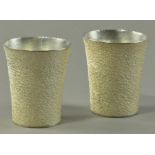 HIROSHI SUZUKI (born 1961); a pair of hallmarked 999 grade fine silver beakers, hammer raised,