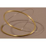 MARLENE McKIBBIN (born 1953); a rocking bangle of spiral form, gold and steel, inner diameter