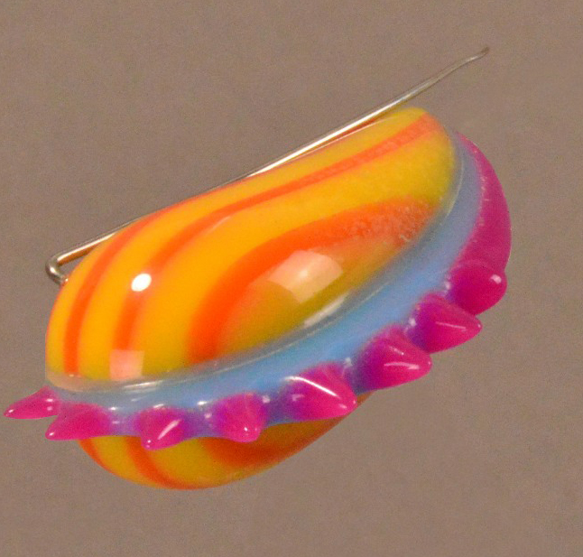 ADAM PAXON (born 1972); a multi-coloured brooch, acrylic, made 1999, length 6.5cm.

Provenance: