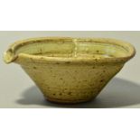 ALAN BRUNSDON (born 1944); a stoneware mixing bowl with lip, covered in a green ash glaze,