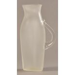 STEVEN NEWELL (born 1948); a tall flat opaque glass jug, incised signature, height 29cm.