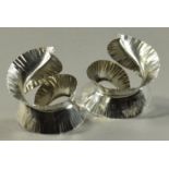 RAUNI HIGSON (born 1970); a pair of hallmarked silver napkin rings of spiral feather form, London