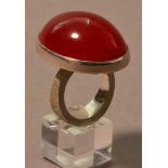ROBERT FEATHER (born 1951); a hallmarked silver ring with large amber stone, ring size R.