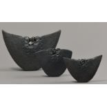 MAGGIE BARNES; a set of three hand built crescent shaped organic inspired forms, burnished black