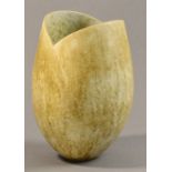 JOHN WARD (born 1938); a stoneware tulip form, coil built with a cut rim, mottled greenish glaze,