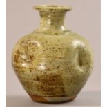 JIM MALONE (born 1946); a 'bashed' stoneware bottle, green ash glaze, impressed JM mark, height 22.