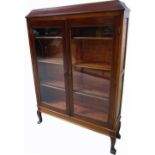 A 20th century glazed mahogany bookcase on cabriole legs, 168 x 114cm.