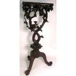 A 19th century Oriental heavily carved plant stand.