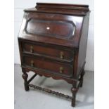 A 20th century oak bureau on barley twist and turned block supports, width 72cm.