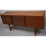 A G-plan style sideboard on block supports, approx width 170cm.