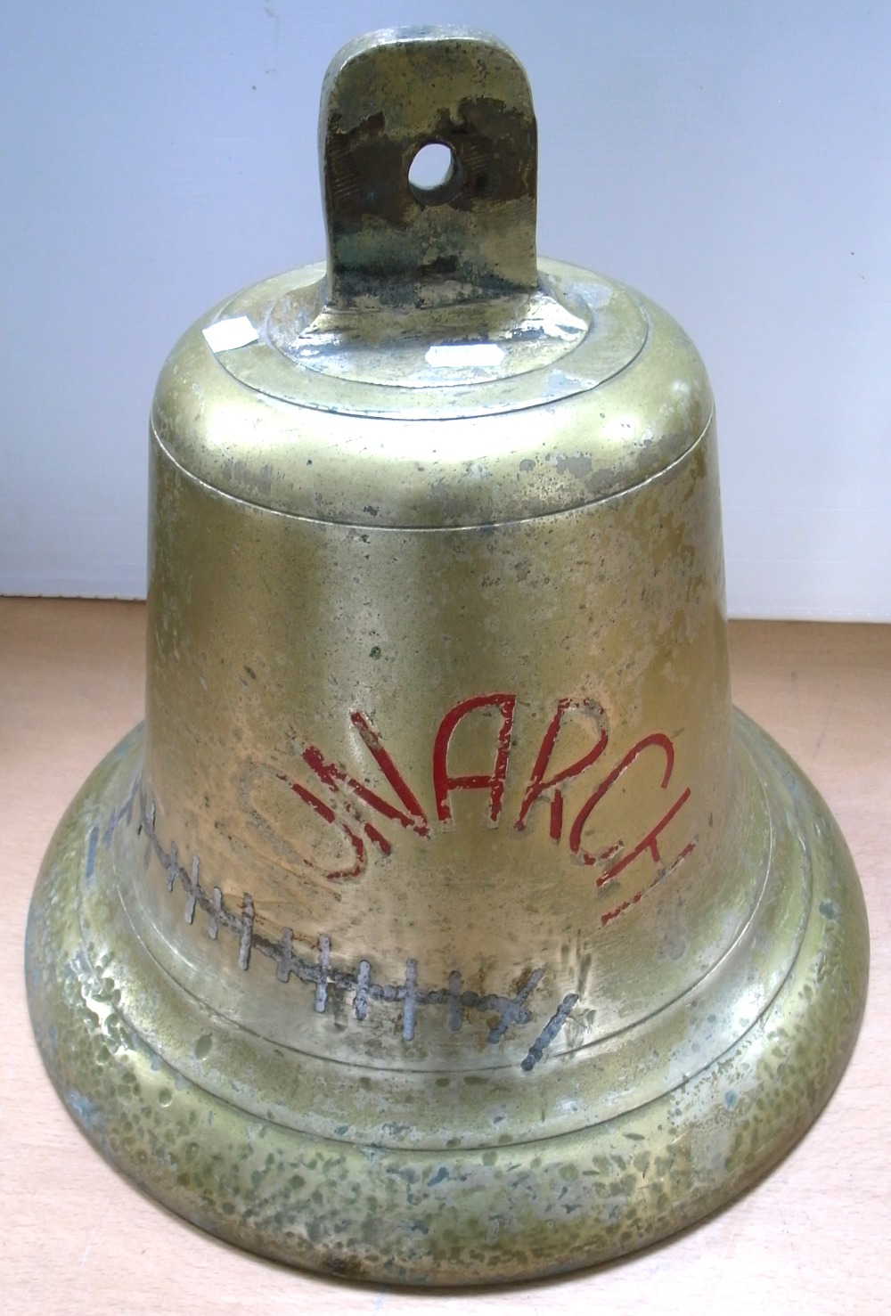 A large brass ship's bell, "Monarch",
