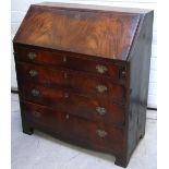 A Georgian mahogany bureau with brass handles and escutcheons on bracket feet,