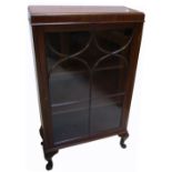 A walnut single door glazed display cabinet raised on squat cabriole legs.