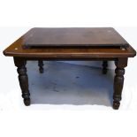 An early 20th century wind out table with central leaf on turned baluster legs terminating in