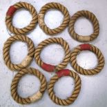 A C.1950s set of eight rope deck quoits, four red and four white.