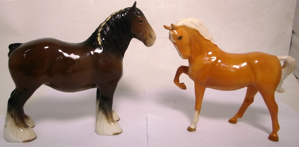 A Beswick shire horse brown mare height 22cm and a Palomino height 19cm (af) (2). CONDITION REPORT