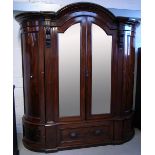 A Victorian mahogany wardrobe/linen press a central two mirror door flanked either side by bow