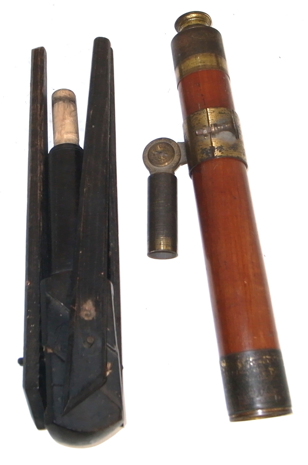 An early 20th century three drawer wood and brass telescope and table top tripod.