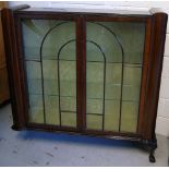 A retro twin door astragal glazed display cabinet on claw and ball feet with two glass shelves to