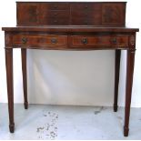 A reproduction mahogany serpentine front escritoire or writing desk on square section tapering