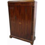 A mahogany Art Deco style inlaid tall cupboard with one central drawer and reeded columns to either