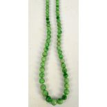 An apple jade graduated bead necklace with silver clasp set with pearls and marcasite, length