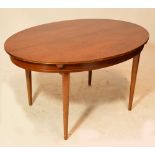 A reproduction oval dining table with internal additional leaf and raised on turned legs.