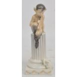 A Royal Copenhagen model of Pan seated upon a column with flying squirrel at the base, printed