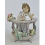 A Lladro figure of a girl on a balcony playing with a bird, height 23cm. CONDITION REPORT: A few