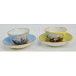 A pair of c.1900 German miniature cups and saucers in blue and yellow, each hand painted with