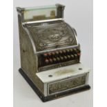 An early 20th century National Cash Register with glazed viewing section, floral embossed main panel