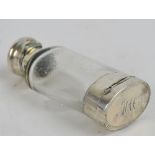 A late 19th century white metal mounted combination vinaigrette/clear glass scent bottle with