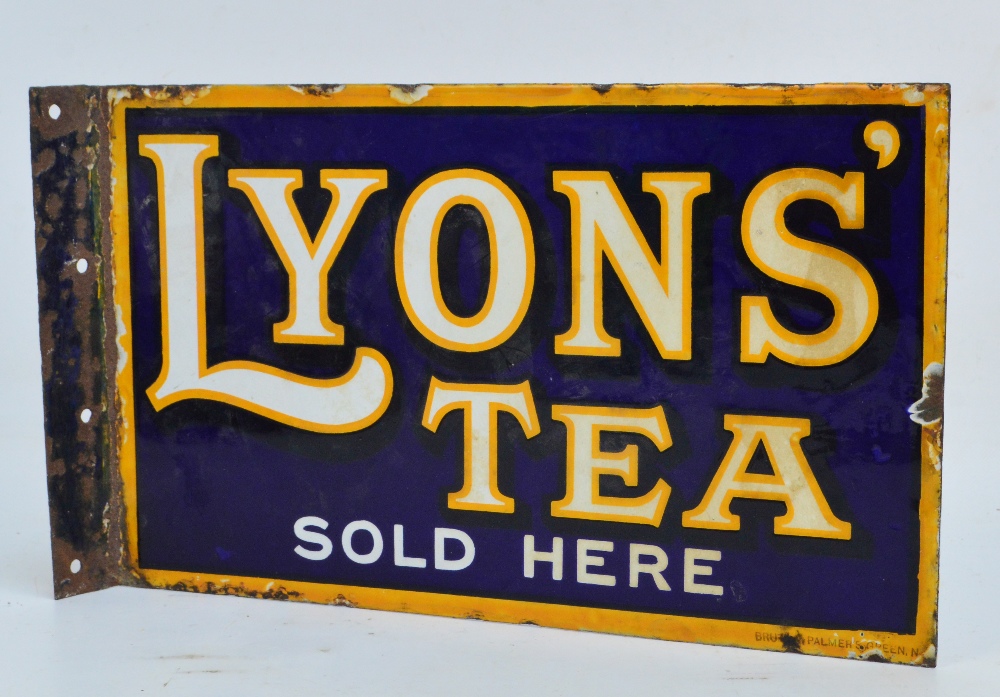 A vintage enamelled iron double sided sign, "Lyons' Tea Sold Here", with flange, 39 x 23cm.