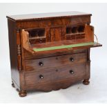 An early 19th century mahogany secretaire chest of drawers,