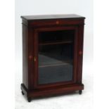 A late Victorian walnut and pine pier cabinet, the rectangular top above glazed door, plinth base,