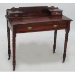 An Edwardian writing table with frieze drawer and ring turned legs to castors, width 91cm.