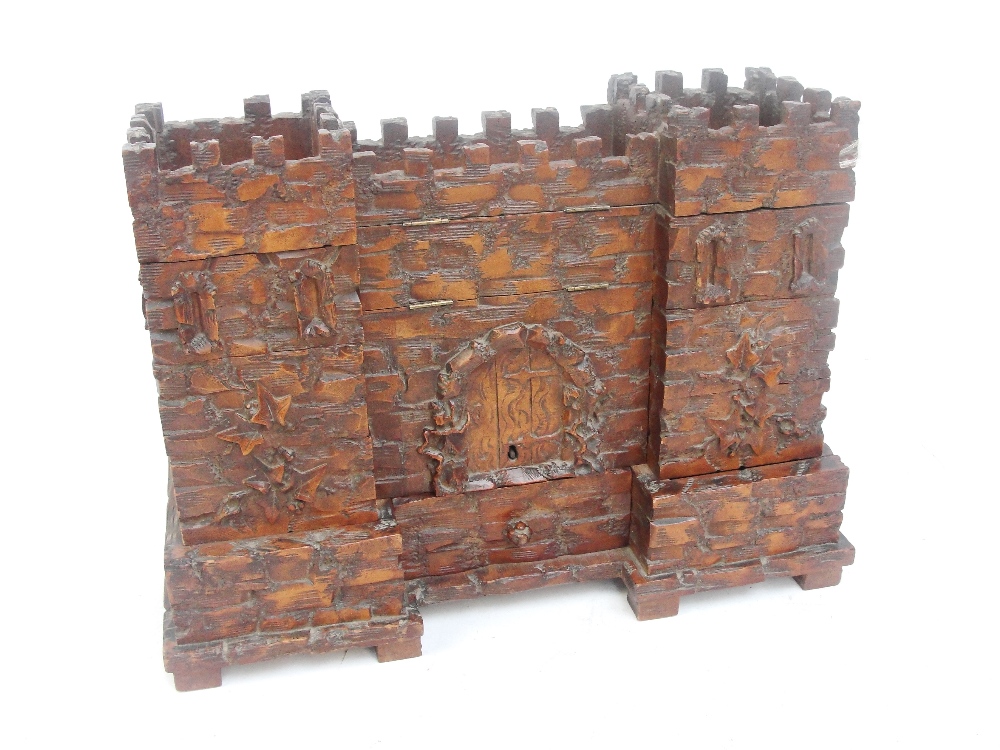 An unusual late 19th century carved oak Black Forest jewellery box modelled as a castle, the central