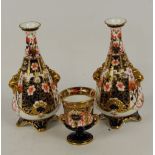 A pair of Royal Crown Derby Imari decorated tapering baluster vases with gilt applied moulded