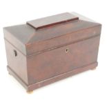 An early Victorian mahogany sarcophagus shaped tea caddy with hinged lid enclosing three