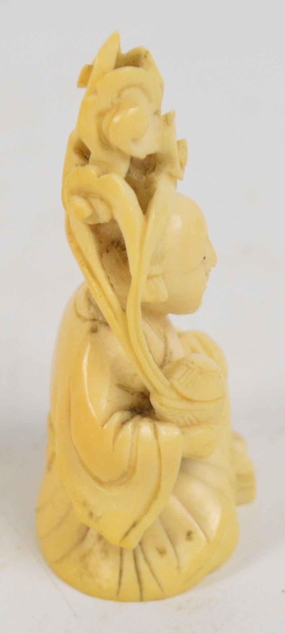 A 19th century Japanese carved ivory okimono depicting a seated man holding a blossoming nut, - Image 5 of 5